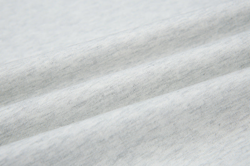 DAXUEN Short-sleeved T-shirt with metallic emblem and pleated details
