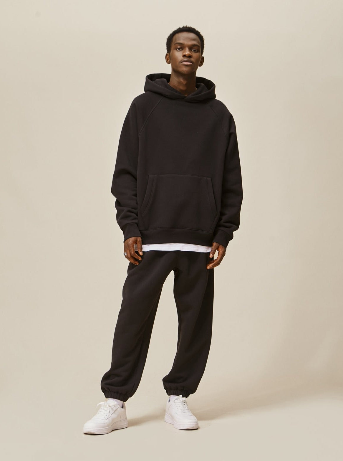 A guy wearing black Explorer tracksuit front view
