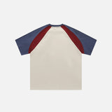 Back view of the beige Y2K Letter Striped Print T-shirt in a gray background from DAXUEN.