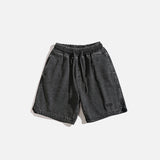 Front view of the black Vintage Washed Denim Shorts in a gray background