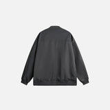 Back view of the dark grey Steller Design Jacket in a gray background
