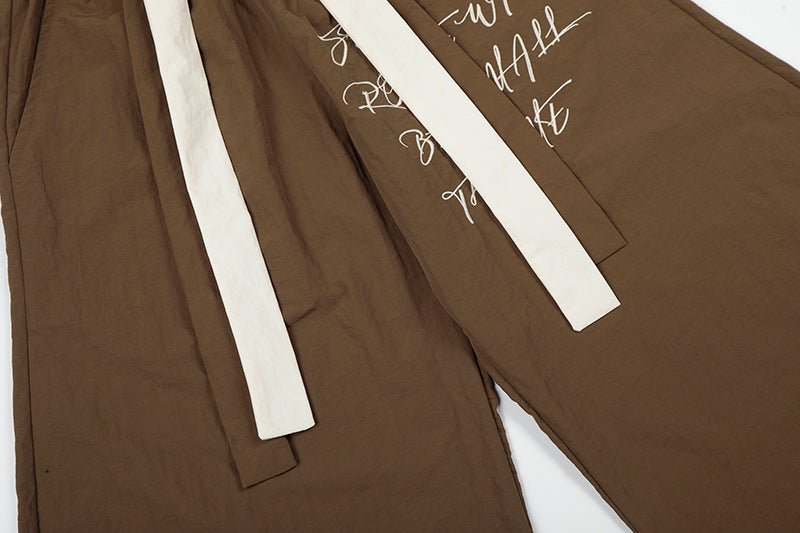 DAXUEN Graphic wide-leg trousers in black and mocha