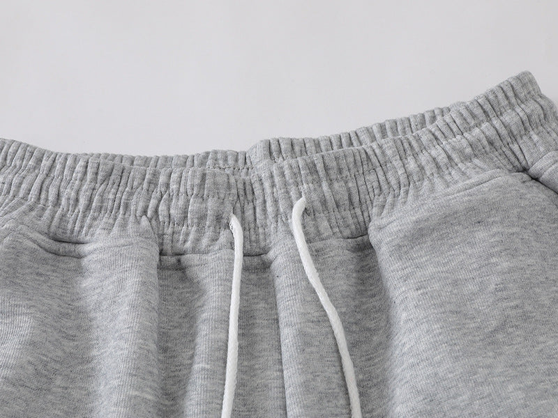 Grey wide-leg sweatpants with patchwork designs
