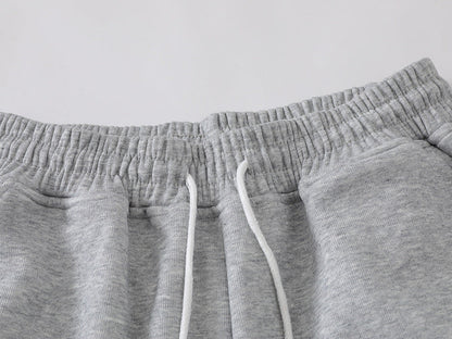 Grey wide-leg sweatpants with patchwork designs