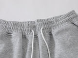 Grey wide-leg sweatpants with patchwork designs