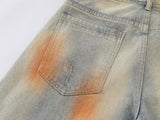 Distressed paint-splatter wide-leg denim jeans
