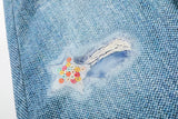 Light blue wide-leg denim culottes with abstract patterns