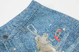 Light blue wide-leg denim culottes with abstract patterns