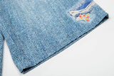 Light blue wide-leg denim culottes with abstract patterns