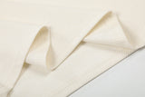 DAXUEN Asymmetrical collar short-sleeve top in cream and black