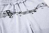 DAXUEN Grey wide-leg sweatpants with musical print and plaid details