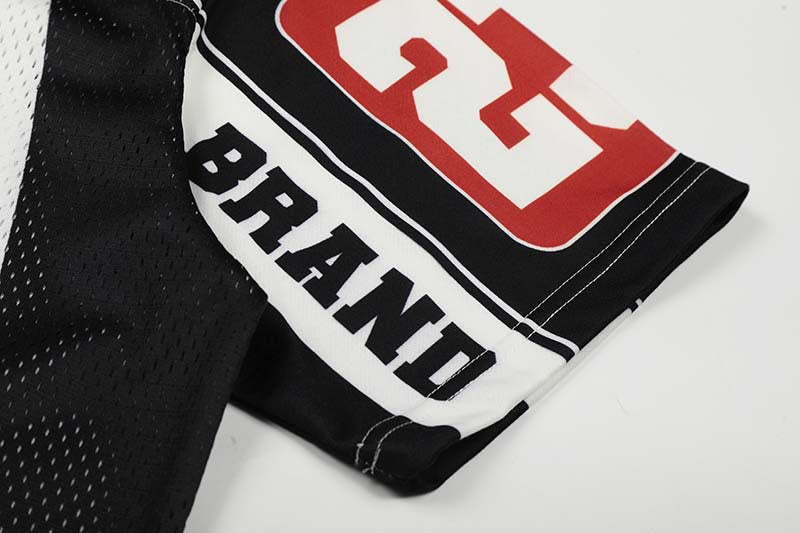 DAXUEN Black and white graphic V-neck t-shirt with red accents