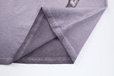 DAXUEN Washed oversized graphic t-shirt with dollar bills and 'misery' print