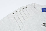 DAXUEN Short-sleeved T-shirt with metallic emblem and pleated details