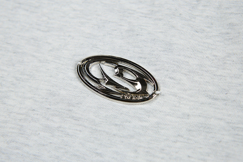 DAXUEN Short-sleeved T-shirt with metallic emblem and pleated details
