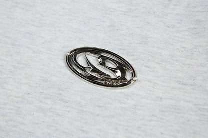 DAXUEN Short-sleeved T-shirt with metallic emblem and pleated details