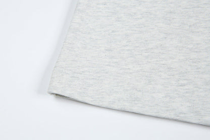 DAXUEN Short-sleeved T-shirt with metallic emblem and pleated details