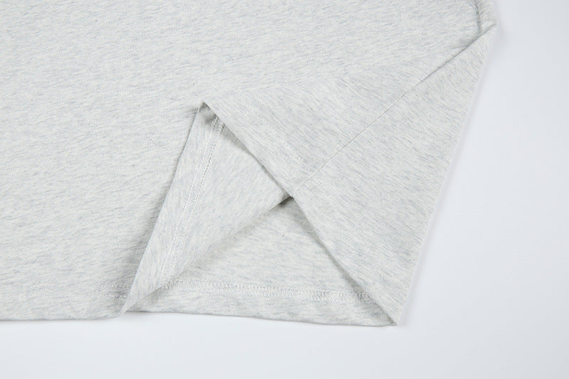 DAXUEN Short-sleeved T-shirt with metallic emblem and pleated details