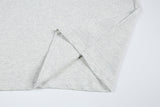DAXUEN Short-sleeved T-shirt with metallic emblem and pleated details
