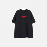 Front view of the black Patchwork Embroidered Eye T-Shirt in a gray background