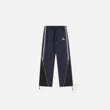 Front view of the navy Y2K Loose Patchwork Cargo Pants in a gray background