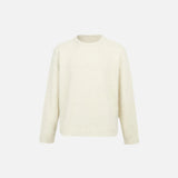 Front view of the apricot Classic Crew Neck Sweater in a gray background