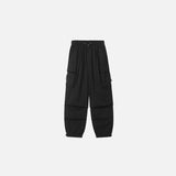 Front view of the black Oversized Baggy Cargo Pants in a gray background 
