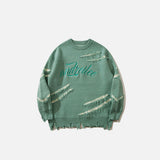 Front view of the green Ripped Artisan Sweater in a gray background 