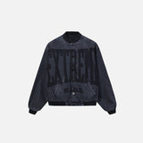 Front view of the black Y2k Washed Denim Jacket in a gray background 