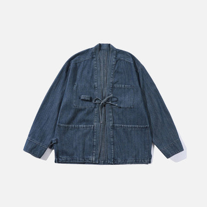 Front view of the blue Relaxed Utility Wrap Jacket in a gray background