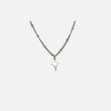 Front view of the Y2K Starburst Necklace in a gray background
