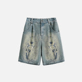 Front view of the blue Divine Print Denim Shorts in a gray background