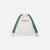Front view of the apricot Aero-Emblem Sweatshirt in a gray background