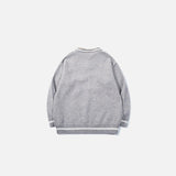 Back view of the grey Vintage Drawstring Oversized Sweater in a gray background