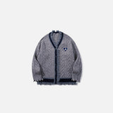 Front view of the grey Vintage Trim Cable Sweater in a gray background