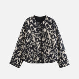 Front view of the black Enchanted Weave Jacket in a gray background