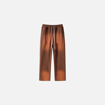 Front view of the brown Casual Noir Relax Pants in a gray background