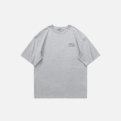 Front view of the grey Loose Short-sleeved Motivate T-Shirt in a gray background 