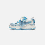 Side view of the blue Galaxy Wave Sneakers in a gray background