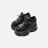 Front view of the black Heart-Tongue Platform Sneakers in a gray background