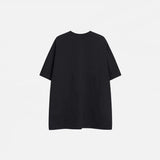 Back view of the black Patchwork Embroidered Eye T-Shirt in a gray background