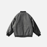 Back view of the dark grey Neoism Varsity Jacket in a gray background
