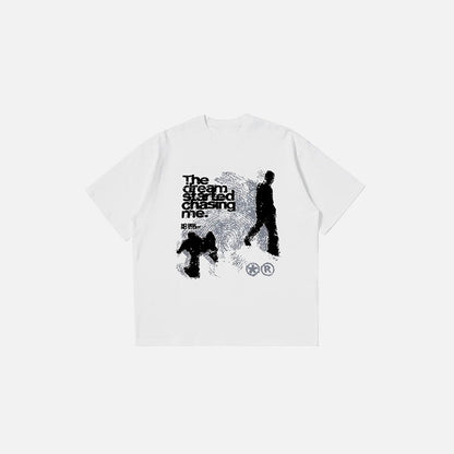 Front view of the white Dream Chaser Graphic T-shirt in a gray background