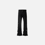 Front view of the black Edgy Black Flared Jeans in a gray background
