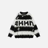 Front view of the black Oversized Ripped Loose Sweater in a gray background 