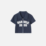 Front view of the royal blue Women's Retro Graphic Polo Shirt in a gray background