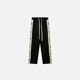 Front view of the black Side Striped High-waist Sweatpants in a gray background 