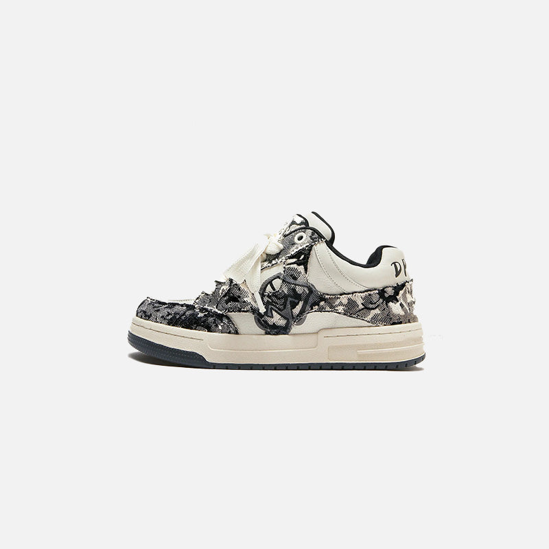 Front view of the black Flow Striders Sneakers in a gray background