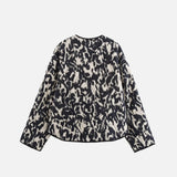 Back view of the black Enchanted Weave Jacket in a gray background