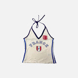 Front view of the beige Halter 90s Style France Top in a gray background